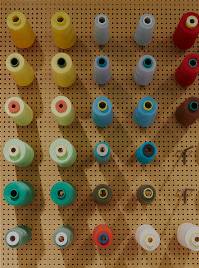 Coloured cotton reels stored on a board