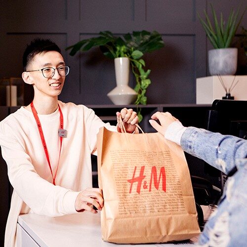 Man serving a customer at a cash desk