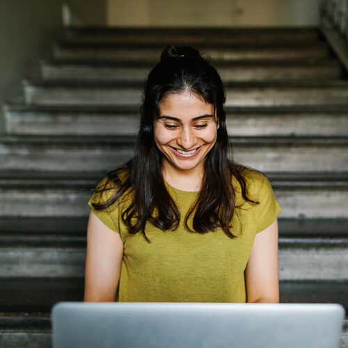 Female looking down at a laptop