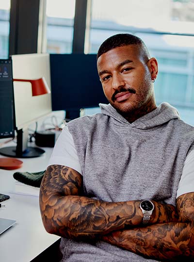 Man sat at a desk looking at the camera