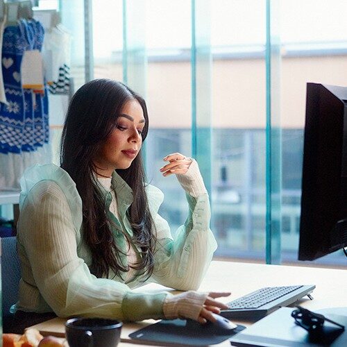 Female sat a computer typing