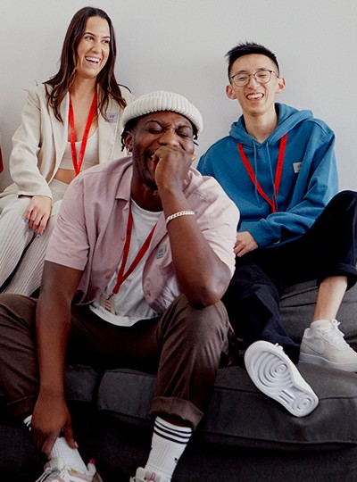 group of people together on the couch, laughing