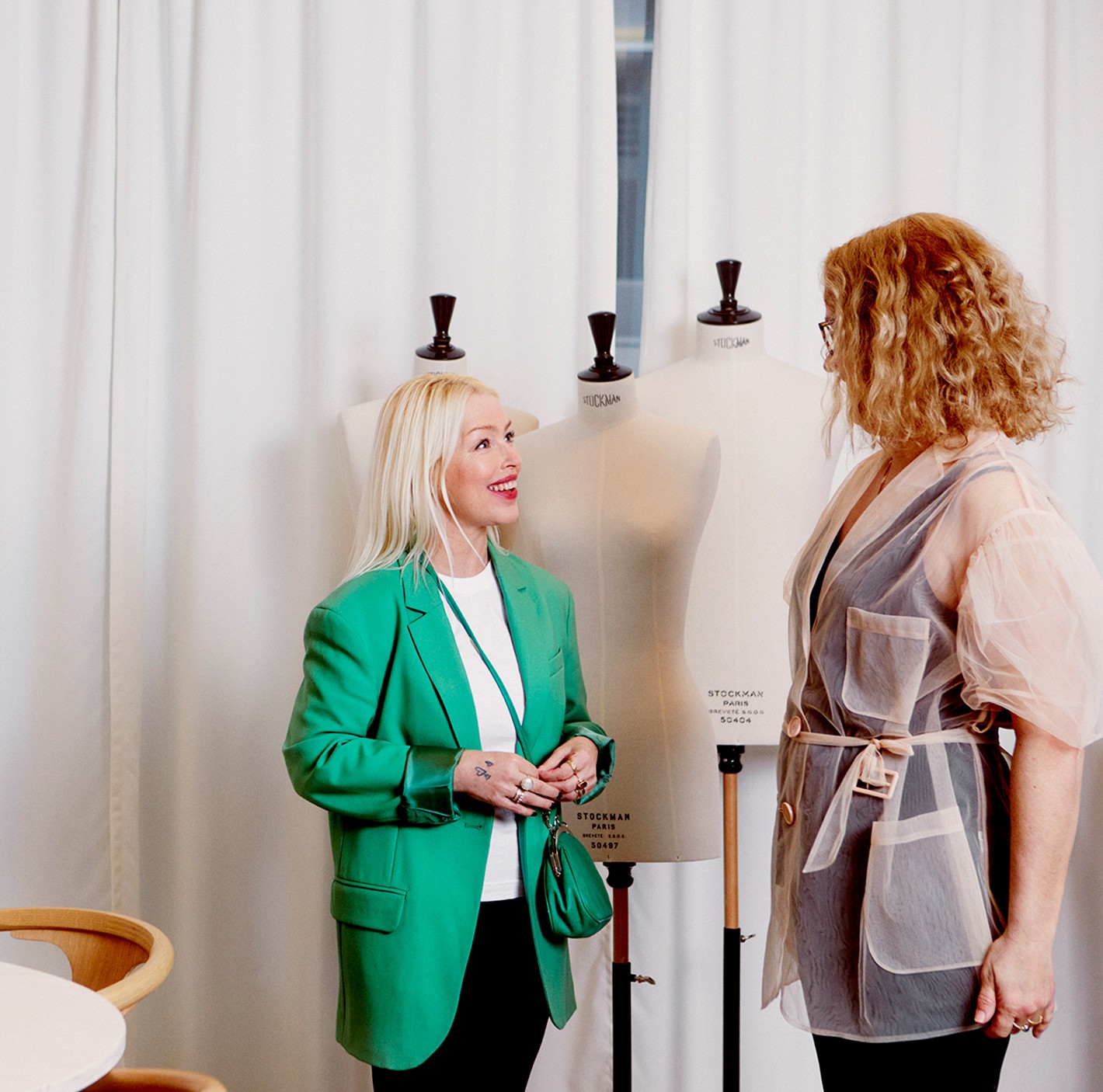 Two females stood facing each other talking